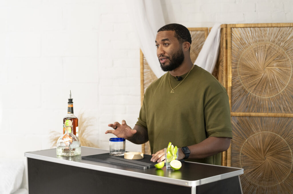 Host leading a cocktail-making demonstration