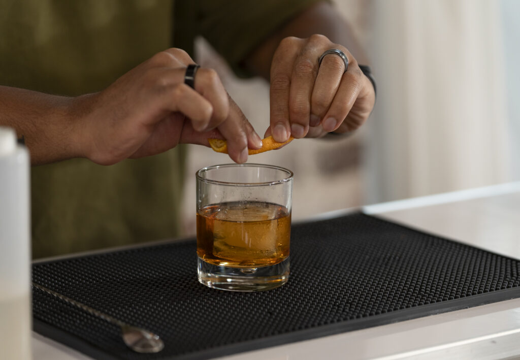 Garnishing a cocktail with a citrus peel